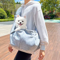 Soft-sided pet carrier with an adjustable crossbody shoulder strap.
