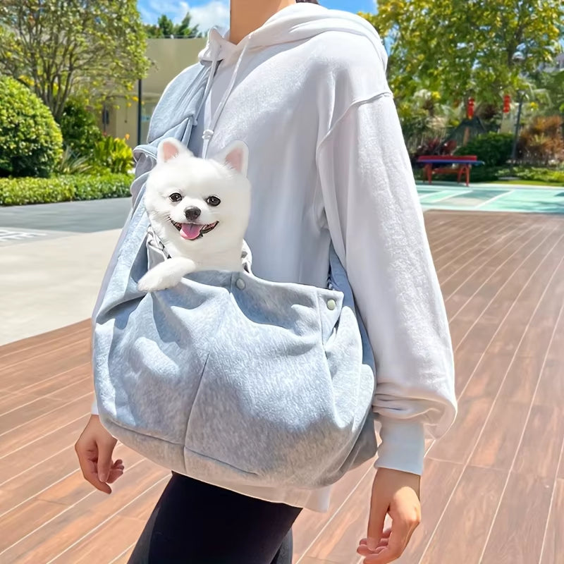 Soft-sided pet carrier with an adjustable crossbody shoulder strap.