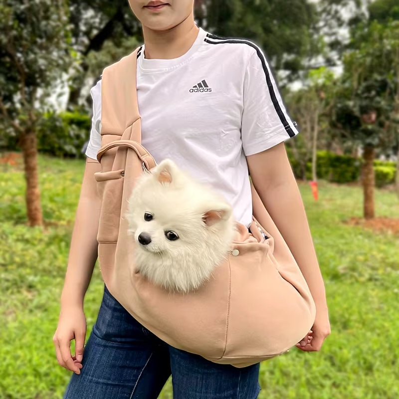 Soft-sided pet carrier with an adjustable crossbody shoulder strap.