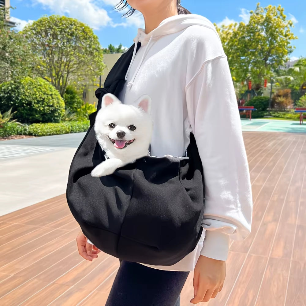 Soft-sided pet carrier with an adjustable crossbody shoulder strap.