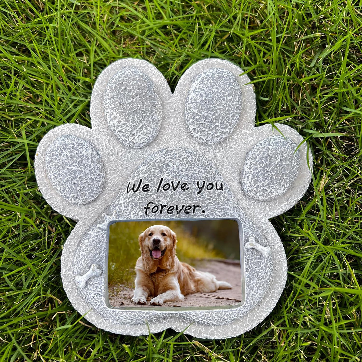 Paw-shaped pet memorial stone with engraved remembrance message.