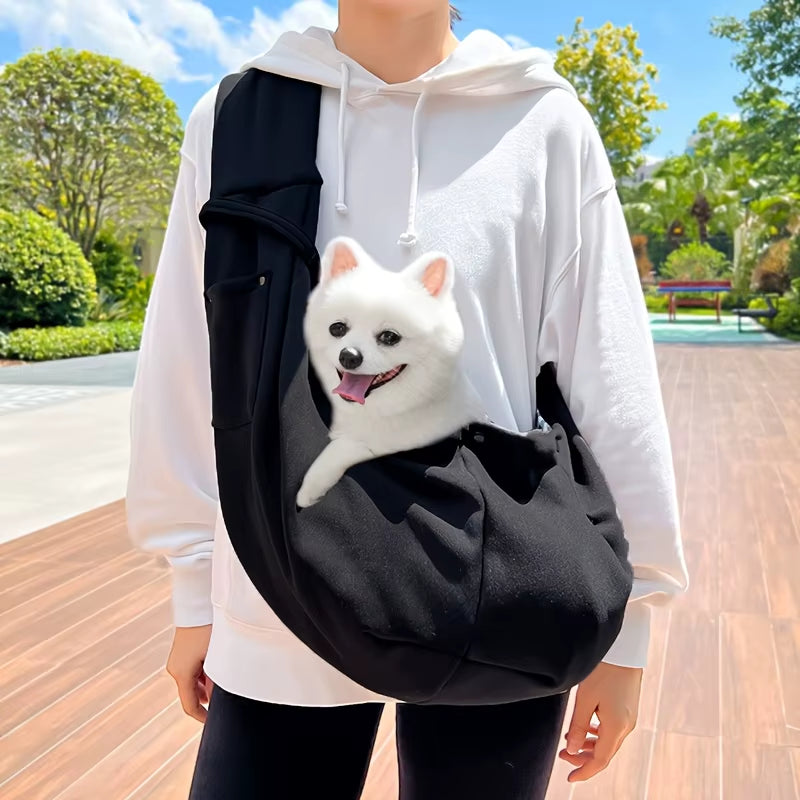 Soft-sided pet carrier with an adjustable crossbody shoulder strap.