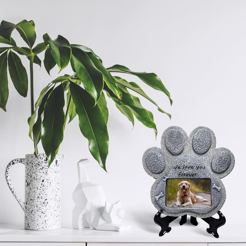 Paw-shaped pet memorial stone with engraved remembrance message.
